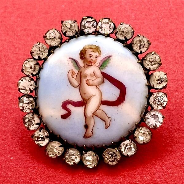 A 19th c. Transfer on porcelain button of cherub.