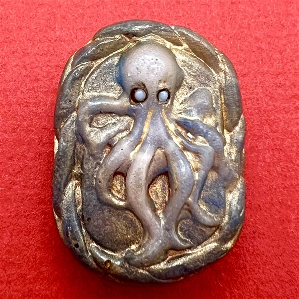 Pâte de verre studio glass button of an octopus by Nancy DuBois.