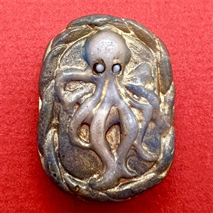 Pâte de verre studio glass button of an octopus by Nancy DuBois.