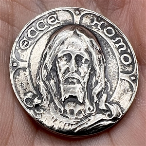 “Jesus” button of silvered metal.