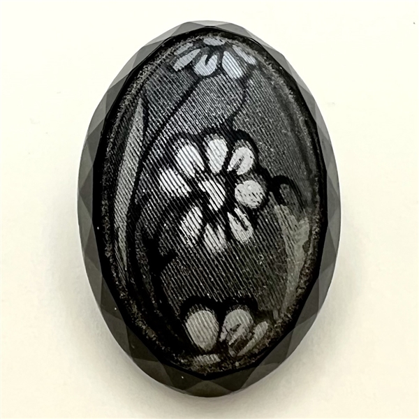 Oval imitation fabric black glass button.