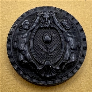 Molded horn button of two Putti.