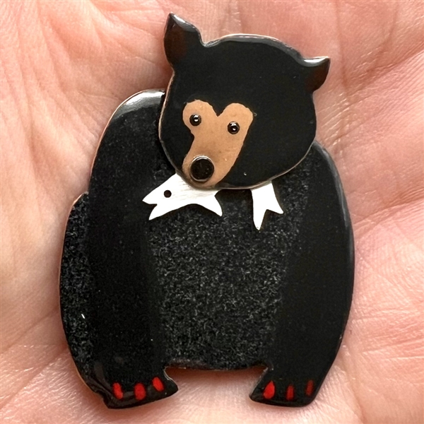 Janet White’s “Black Bear with Supper” enamel on copper studio button.