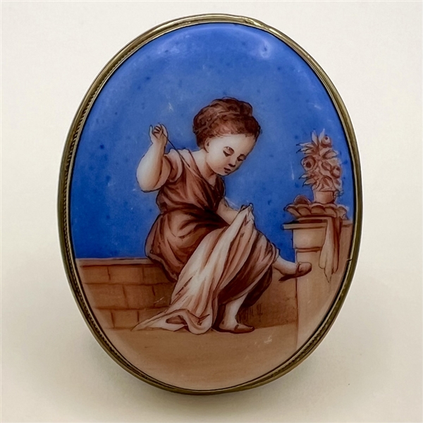 Ceramic oval button of a little girl sewing.