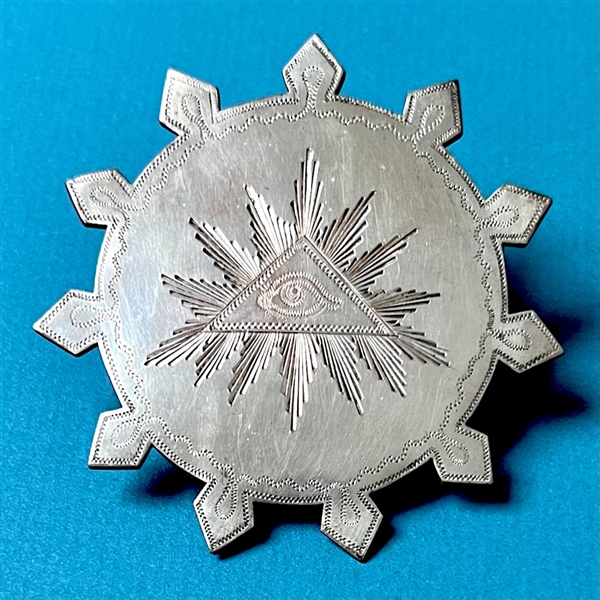 Huge chased and silvered metal button of the “Eye of Providence.”