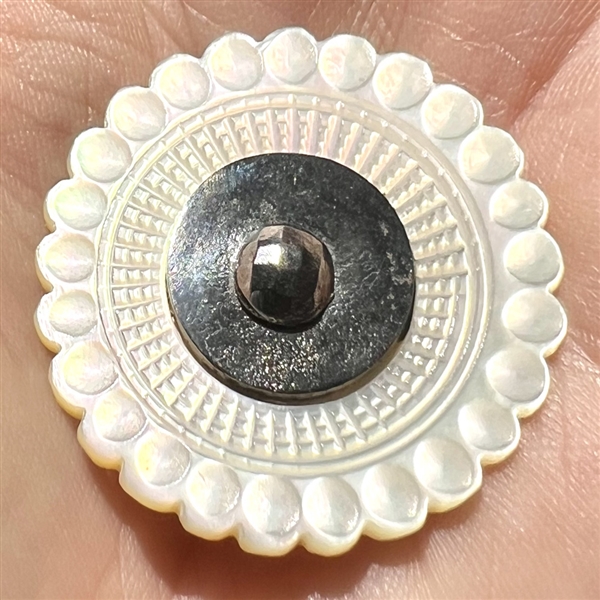 An 18th c. Carved pearl with steel button.