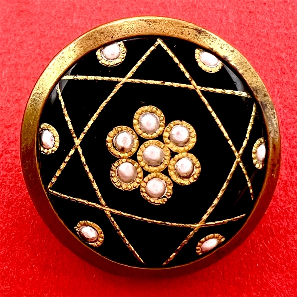 French enamel button of a five pointed star pattern with foil paillons.