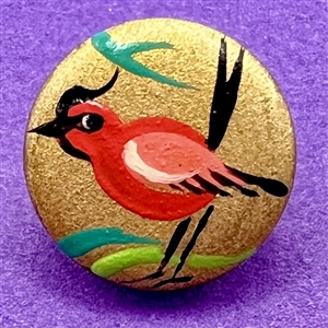 Brooks painted casein button of a red bird.