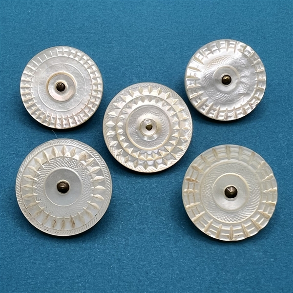 Five thick Colonial pearl buttons.