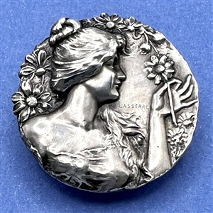 Art Nouveau white metal button of a woman by Lasserre.