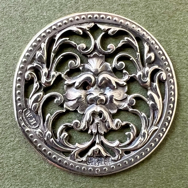 Hallmarked silver button of greenman.