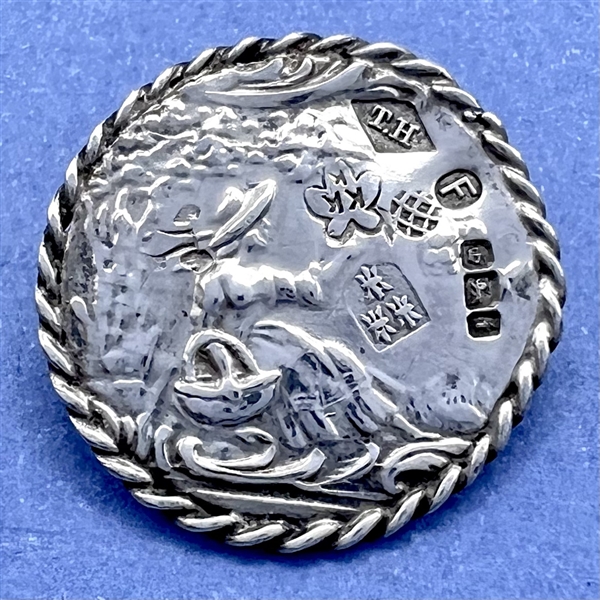 Hallmarked silver button of a girl picking fruit.