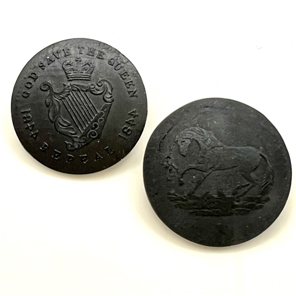 Two buttons of molded horn. The verbal is an Irish Repeal button from the mid 1800s.