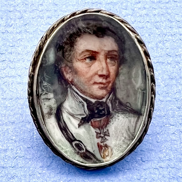 An 19th c. painting under glass of a man set in unmarked silver button.