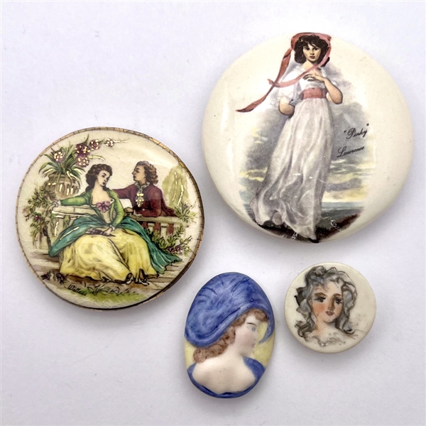 Four ceramic studio buttons by various artists.