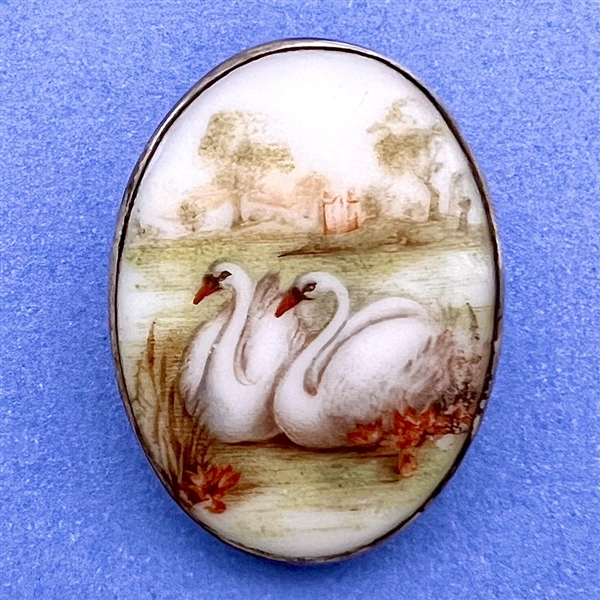 Porcelain button of two swans.