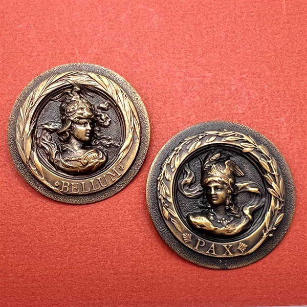 Two sculptural buttons of “Bellum”and “Pax” (War and peace).