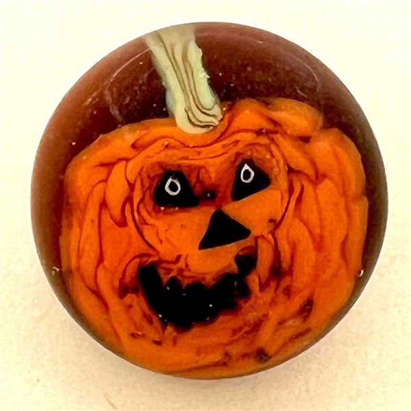 Mary Gaumond’s jack-o-lantern studio glass button.