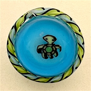 Studio glass button of a turtle by Mavis Smith.