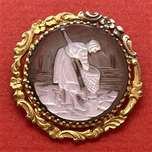 Carved pearl button of woman gathering with a net.