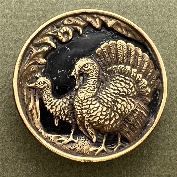 Brass button of two turkeys.