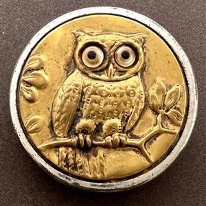 Brass button of fat horned owl with glass eyes.