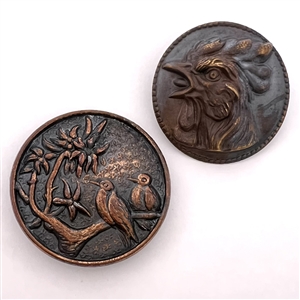 Two metal buttons of birds.