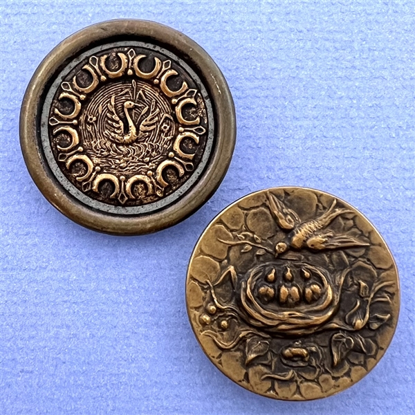 Two brass buttons of birds.