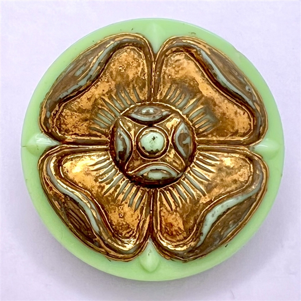 Iridescent brown pearl button with stylized brass fleur-de-lis design.