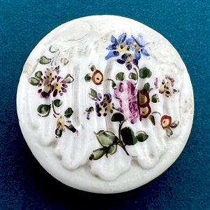 An 18th c. Transitional Mennecy ceramic button of flowers.