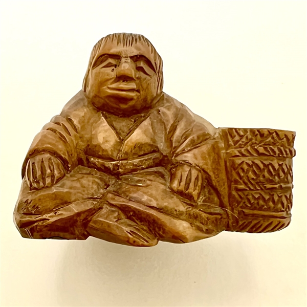 Seated man with basket netsuke.