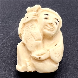 Man holding a fish netsuke.