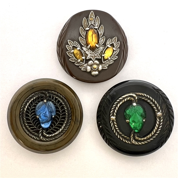 Three Vintage plastic coat buttons with white metal and glass.