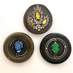 Three Vintage plastic coat buttons with white metal and glass.