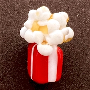 Mary Gaumond’s “Popcorn” studio glass button.