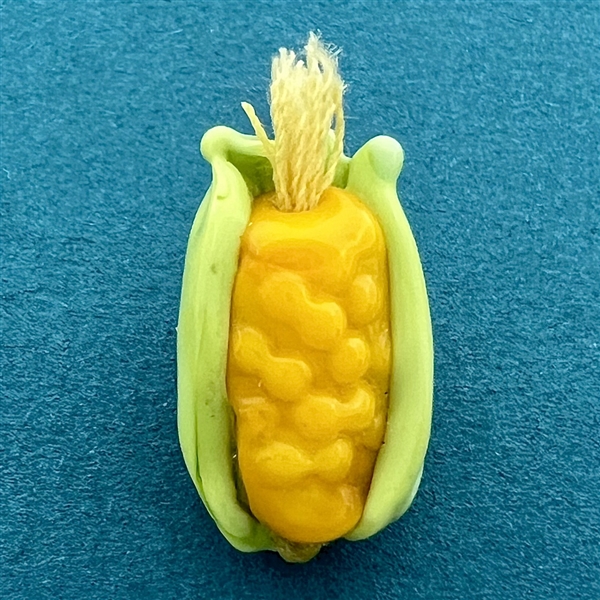 Mary Gaumond’s “Ear of Corn”studio glass button.