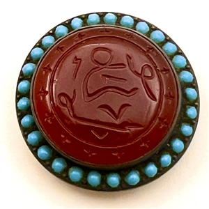 Carved carnelian button with pierreries.