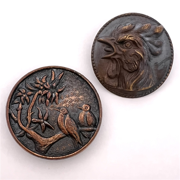 Two metal buttons of birds.