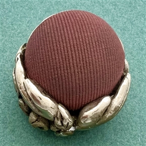 Metalized British Bakelite hands holding fabric ball button.