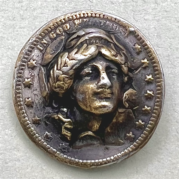 Coin-type metal button of lady liberty. 