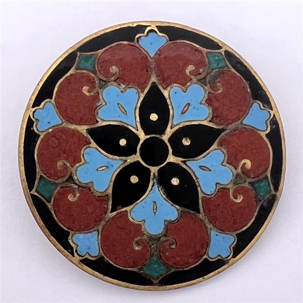 A champlevé enamel button.