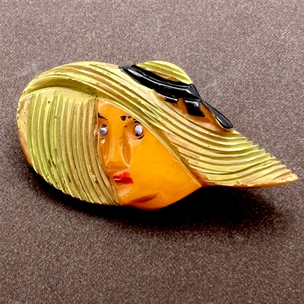 Realistic Bakelite button of a girl in a sun bonnet.