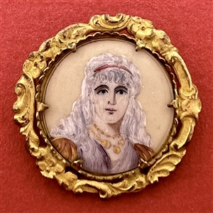 A 19th c. button of a lovely lady in rococo border.