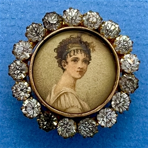 A 19th c. button of woman with beaded head band.