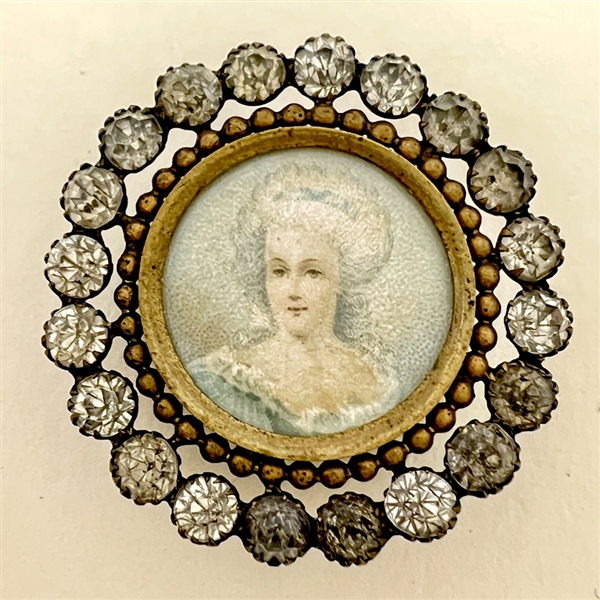 A 19th c. button of woman with white hair.