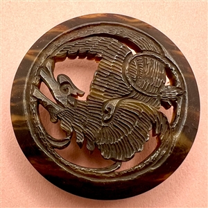 Vintage casein button of a dragon.