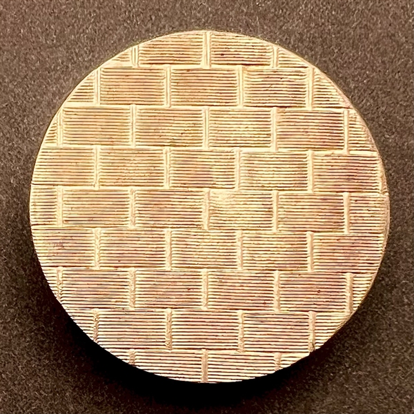 An 18th c. chased copper Colonial button of basket weave pattern.