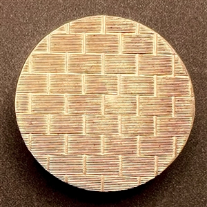 An 18th c. chased copper Colonial button of basket weave pattern.