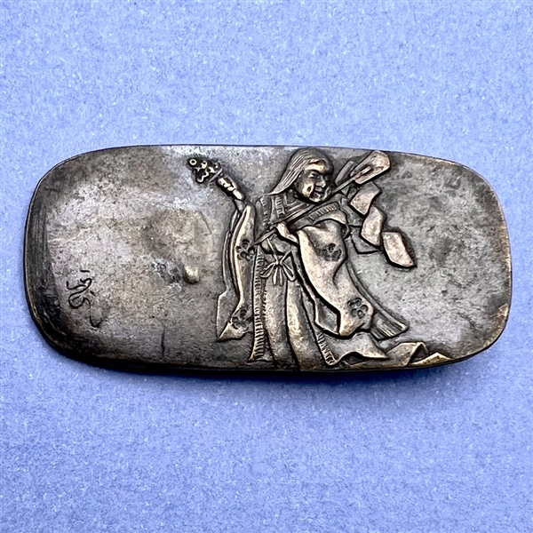 Japanese Shakudo button of a man carrying objects.