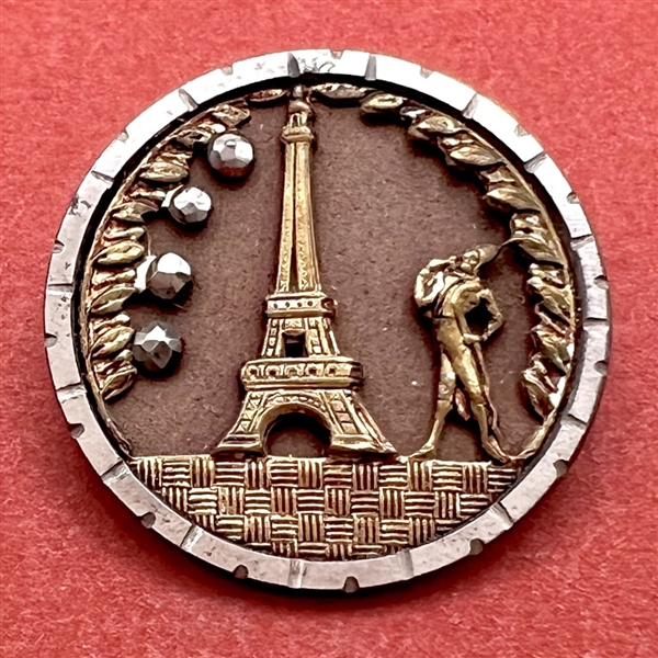 Eiffel Tower and French Fop over brass background button.